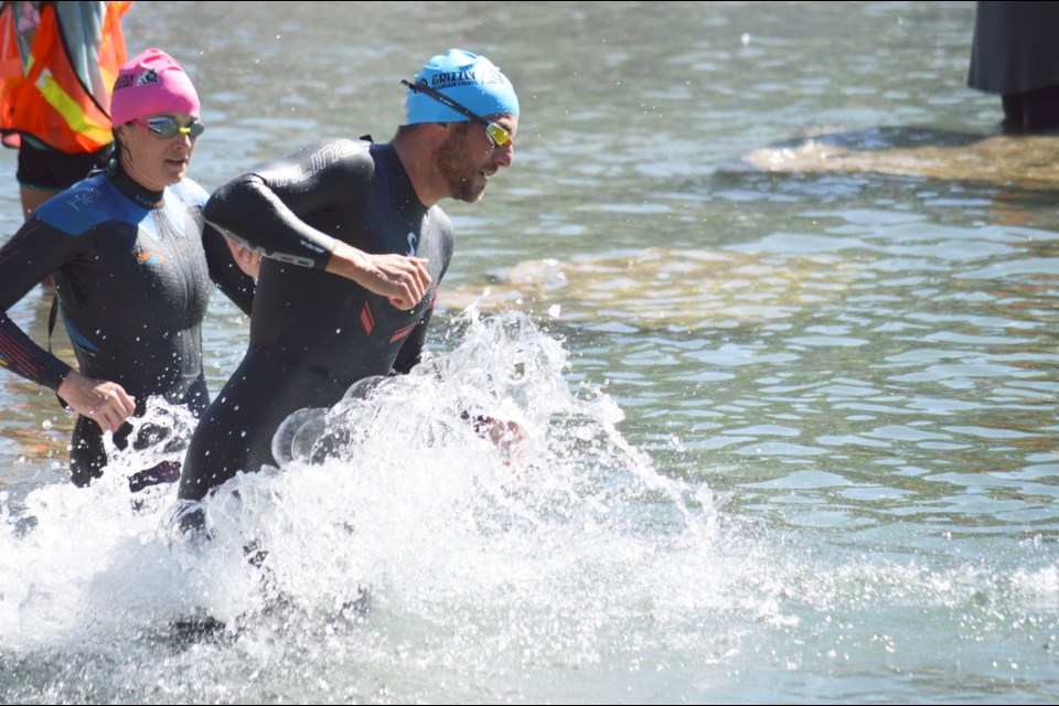 Swimmers dive into Quarry Lake during the 2022 Grizzly Open Water Race on Saturday (July 16). JORDAN SMALL RMO PHOTO