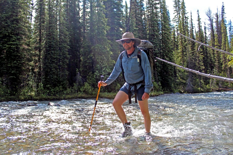 ACMG guide Ken MacDiarmid crosses the Baird Brook river in British Columbia's backcountry. JORDAN SMALL RMO PHOTO