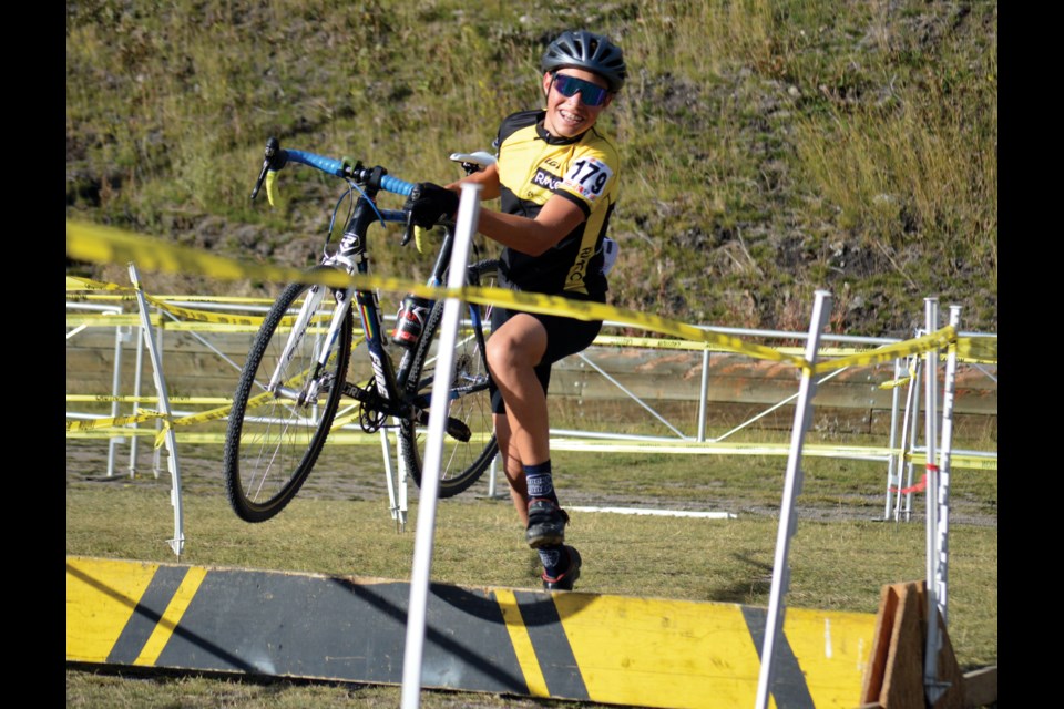RMCC's Quinten Macklem smiles for the camera as he hops over a barrier during Saturday's (Sept. 24) Western Challenge  Cyclocross race at the Canmore Nordic Centre. JORDAN SMALL RMO PHOTO