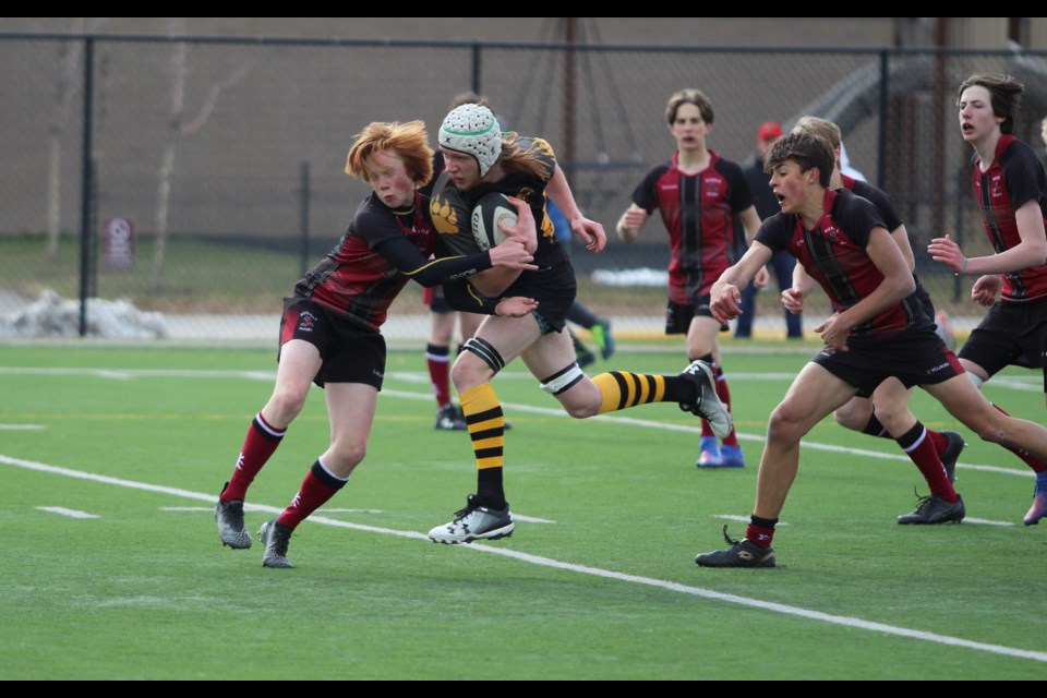 Banff Bear Noah McFarlane collides with a Rundle College Cobra player on May 10 in Calgary. JORDAN SMALL RMO PHOTO
