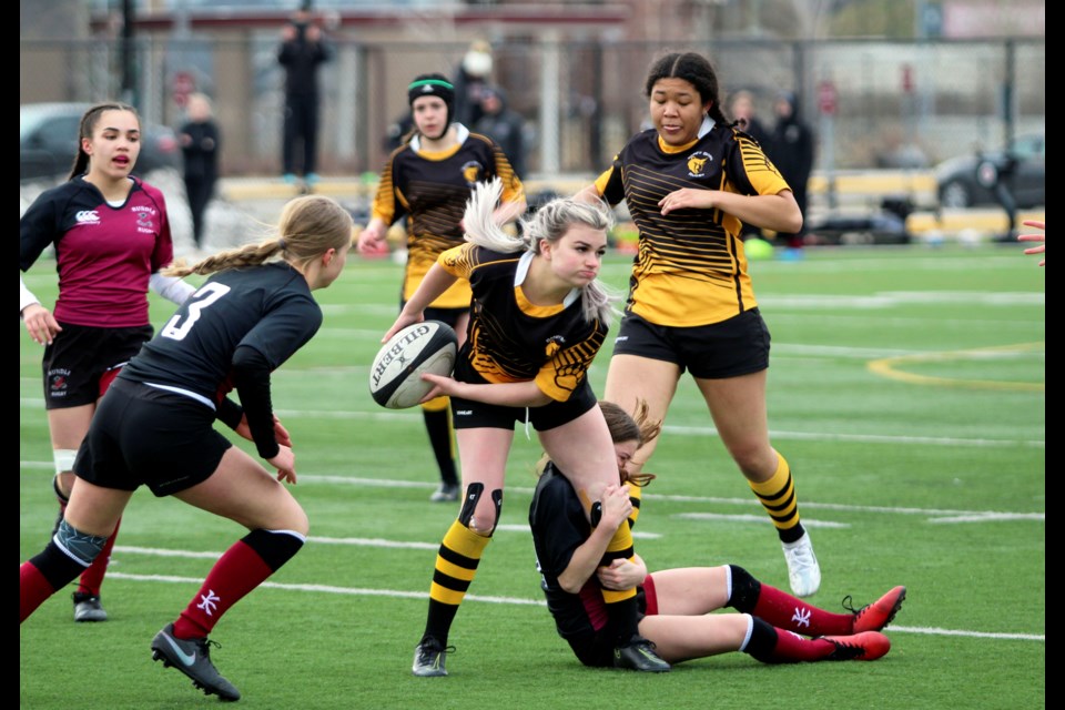 Banff Bear Anika Villemaire tries to shake off a clingy Cobra during Tuesday's match (May 10) at Rundle College in Calgary. JORDAN SMALL RMO PHOTO