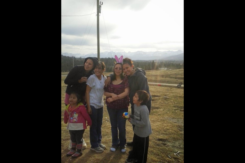 Stoney Nakoda sisters Glynnis Fox (second from left), Tiffany Ear (second from right)  and sister Kaila Ear (right) pose in a photograph together in 2015. Fox and Ear were victims of a quadruple homicide in Calgary in 2017.
SUBMITTED