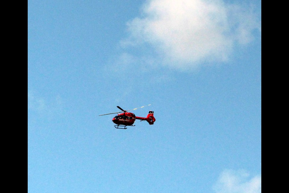 STARS air ambulance flies overhead at the Seebe Dam in search of a possible missing swimmer. JORDAN SMALL RMO PHOTO