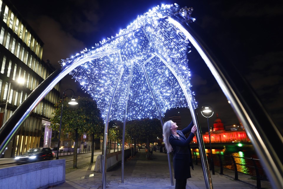 Canmore-based artist Alva Gallagher stands underneath PULSE, her latest art piece, located in Dublin, Ireland. SUBMITTED PHOTO