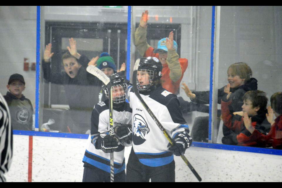 The U15 Canmore Eagles celebrate a goal in the provincial championship game against the Springbank Rockies as Canmore fans bang on the glass. JORDAN SMALL RMO PHOTO