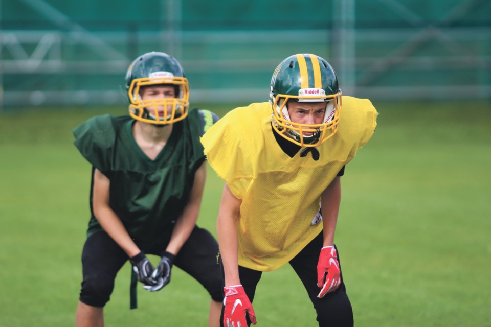Quinn Webster, front, and Asher McKay get ready for the upcoming season during Canmore Wolverines practice. The Wolverinesâ season opener is Thursday (Aug. 29) at 4 p.m. at Millennium Field against the Ardrossan Bisons. Jordan Small RMO Photo