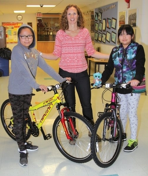 Exshaw physical education teacher Shannon Fox, centre, with Grade 4 students Latiesha Hunter, left, and Ambriel Abraham.