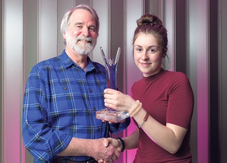 Canmore’s Mayor John Borrowman, left, holds the youth award trophy with winner Senna Odyakmaz during the Mayor’s awards for volunteer excellence at the Canmore Rec Centre in