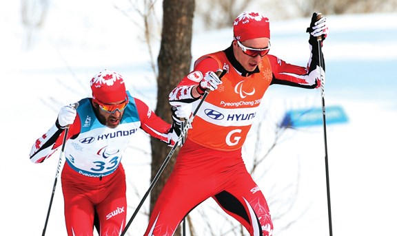 Graham Nishikawa leads Brian McKeever in his gold medal 20-kilometre event in PyeongChang, Korea.