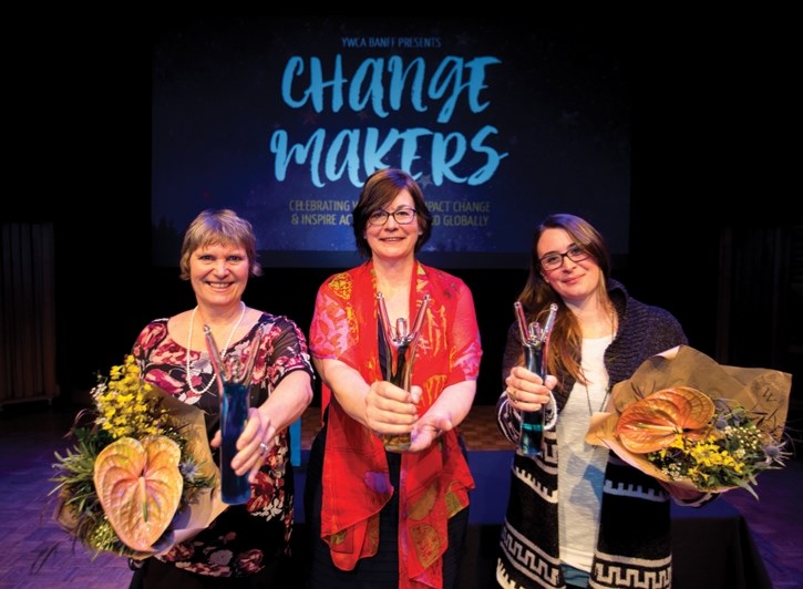 Lorraine Widmer-Carson, left, Allana Pettigrew and C.C. Findlay (on behalf of Dr. Elizabeth Hall-Findlay) hold out this year’s Change Makers awards during the Banff YWCA