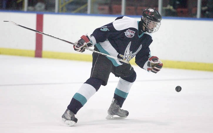 Canmore’s Simon Philp gloves down a puck during his extraordinary debut game with his hometown Eagles Thursday night (Jan. 27).