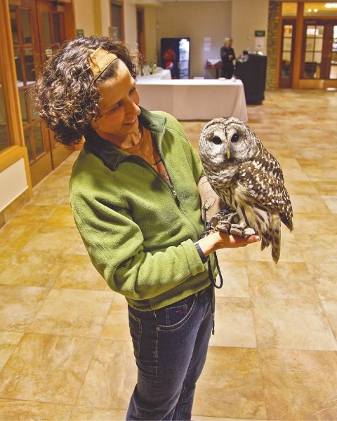 Sandie Hucal holds a barred owl named Colonel Slade.
