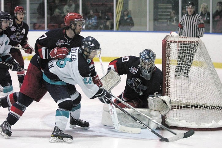 Forward Cody Cartier is tied up by Brooks Bandits defender David Watt during the Eagles 3-1 playoff loss. The Eagles were swept in three games by the Bandits.