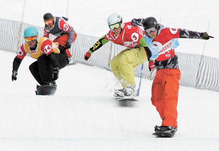 Jared Minghini (second from R) battles through the heats enroute to his victory in Saturday’s (April 9) snowboard cross Canadian championship at Lake Louise.