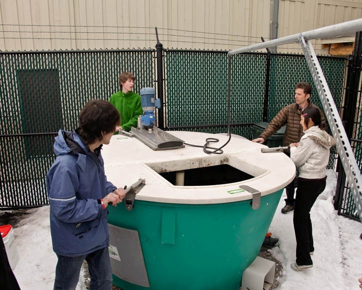 CCHS students stir the Earth Tub Composter while teacher Ken Symington supervises last month.