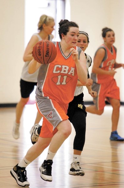 Canmore’s Hillary Newton takes the ball up court for the Calgary Basketball Academy team as they take on Oasis during Peaks basketball tournament action at Lawrence Grassi