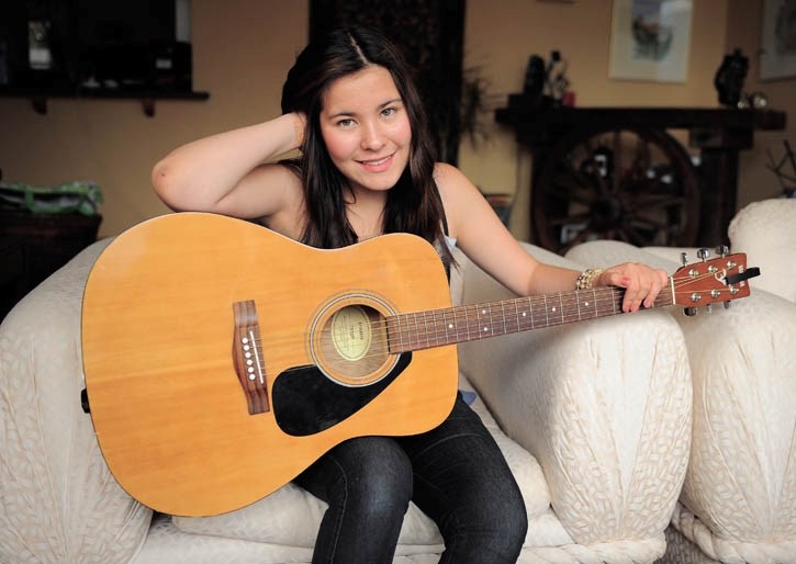 Isabella Pedersen relaxes with her guitar. The Canmore teen will attend UBC this summer on a Shad Valley scholarship.