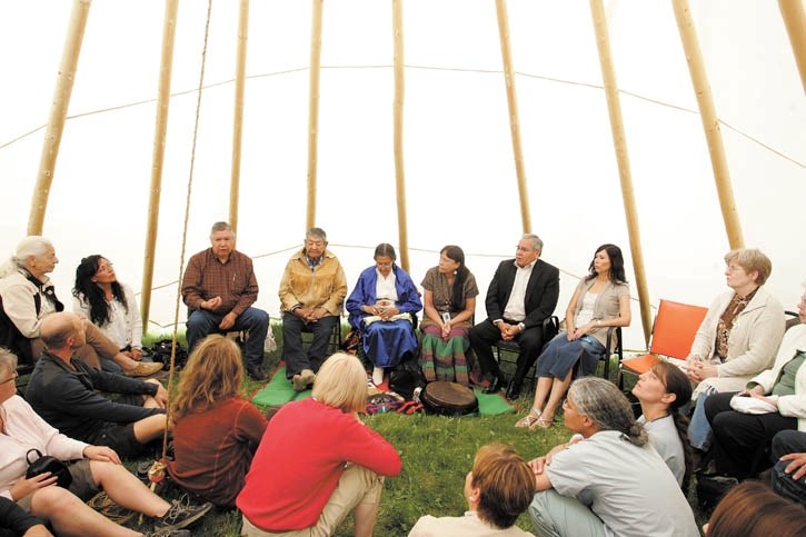 Stoney elder Grace Daniels (centre in blue) prepares to bless the Canmore Hospital teepee with a smudging and pipe ceremony.