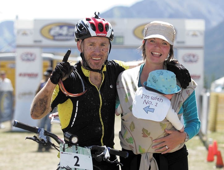 Solo winner Matt Duggan with wife Megan and baby Rhys celebrate at the 24 Hours of Adrenalin at the Canmore Nordic Centre Saturday (July 23).