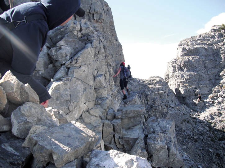 Paul MacMillan, left, watches as Kaleigh Fendley traverses the crux on the way to the peak of Yamnuska.