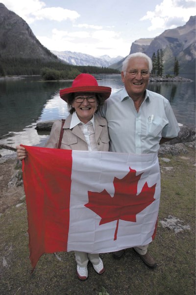 Christine and Alan Pryor of Canmore celebrate their Canadian citizenship on the shore of Lake Minnewanka, Thursday (Aug. 4).