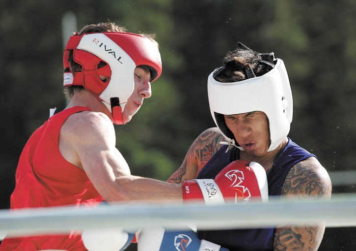 Local fighter Neal Greaney lands solid leather on Jeremy Divina during their K.O. For Cancer bout in Canmore Saturday (Aug. 6).