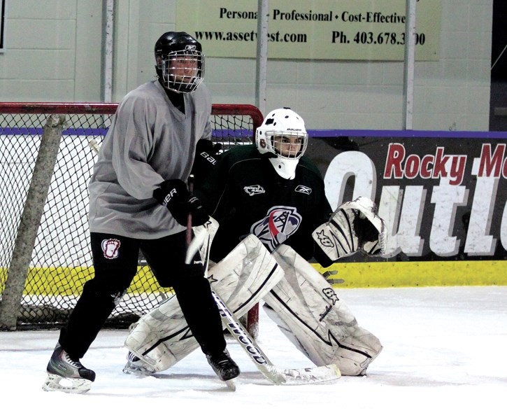 Canmore’s Patrick Dove looks for a tip-in against Medicine Hat goalie Cole Schafer during an Eagles training camp practice, Tuesday (Aug. 23).