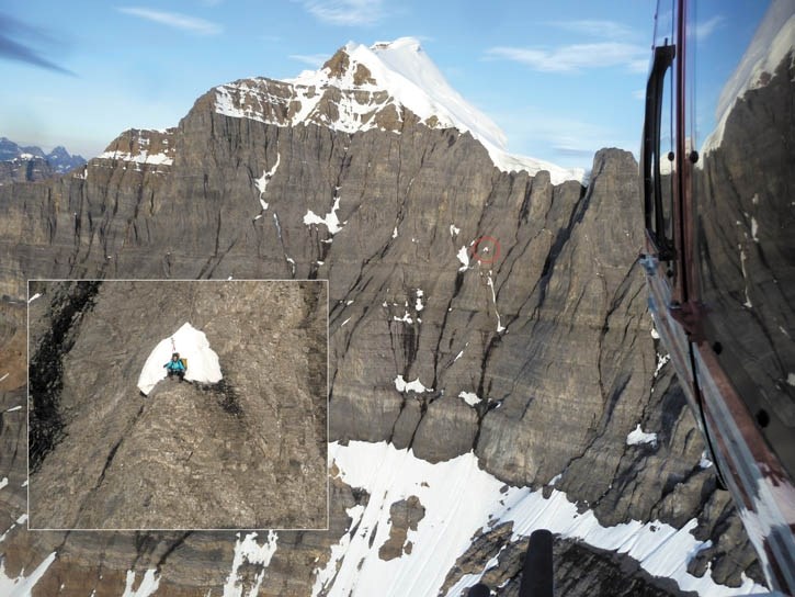 Alpine Helicopters pilot Lance Cooper ferries Parks Canada rescuers Aaron Beardmore and Brian Webster to a ledge on the face of Mt. Temple where two stranded climbers spent