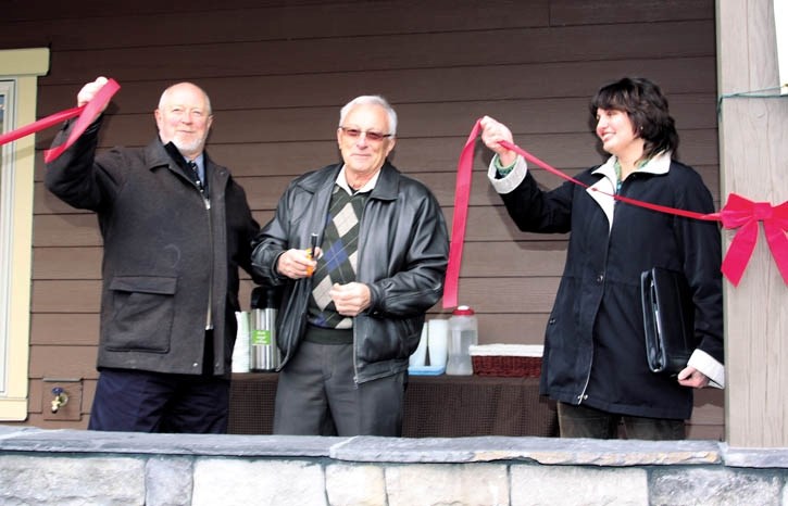 Ron Casey, Bob Kocian and Cathy-Anne David cut the ribbon on a new CCHC housing project Thursday (Nov. 10).