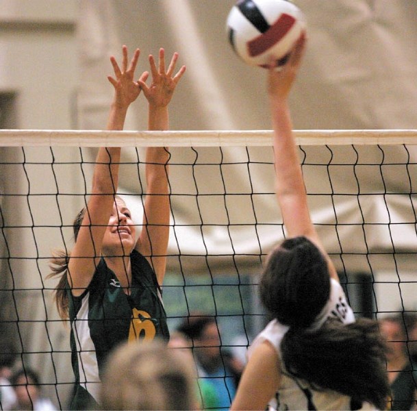 Abby Simpson reaches for a block as the Canmore Collegiate junior varsity team contest the zone championships Saturday (Nov. 19).