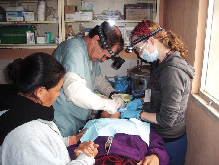 Canmore dentist Lloyd Evans and dental hygenist Arleah Bloxom work on a patient in Guatemala.