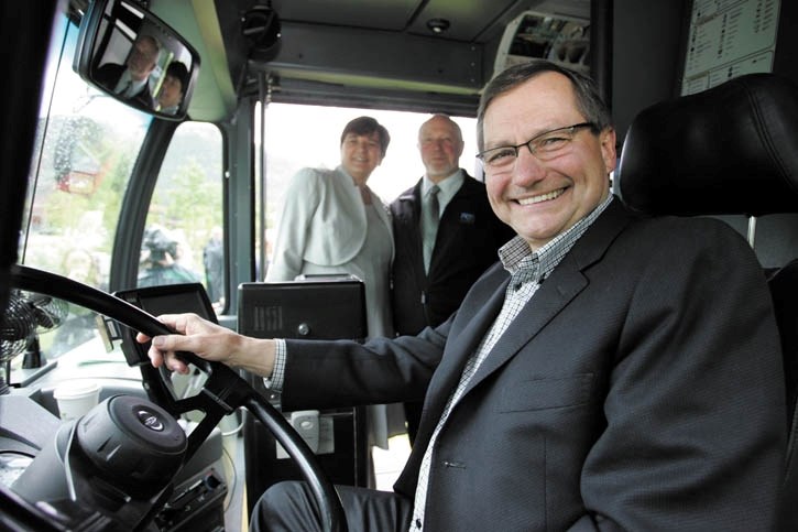 Alberta Premier Ed Stelmach takes the wheel of one of Banff’s Roam buses with Banff Mayor Karen Sorensen and Canmore Mayor Ron Casey on hand at Thursday’s (June 23) Regional