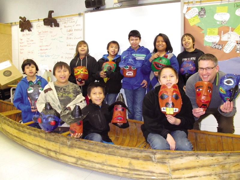 The Black Canoe literacy group at Exshaw School pose with their Haida-inspired masks.