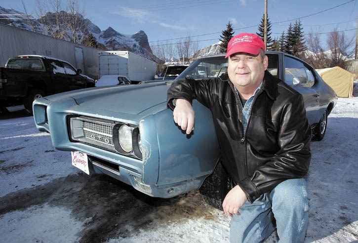 Canmore resident Bruce McTrowe poses with his 1969 Pontiac GTO.