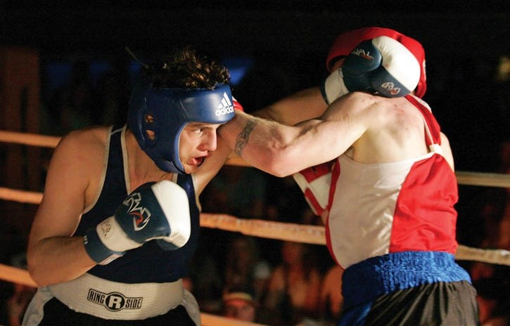 Ashton Lynwinuk (blue) and Brian Samuel exchange lefts during their bout.