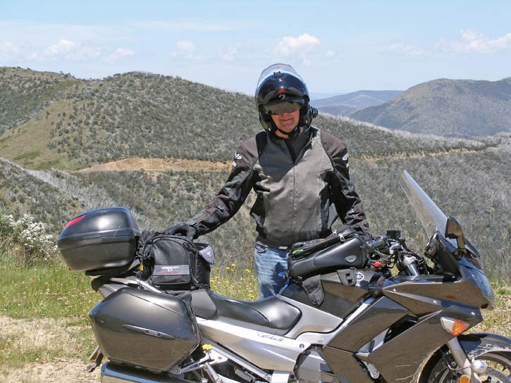 Gregory Waldner stands with his motorcycle on the Great Alpine Road while heading to Melbourne.