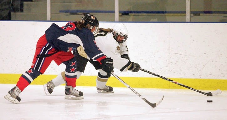 Rhylynn Fowler battles along the boards as the Banff Hockey Academy women’s team host their home tournament on the weekend.