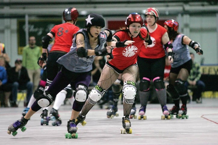 Bow Valley Roller Derby’s Abby “anNamolly” Lever (R) battles for track position during Saturday night’s (June 2) roller derby event at the Canmore Rec Centre. The Bow Valley