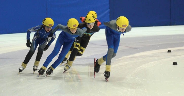 Sam Hendry (right) and Connor Howe (middle) of the Banff/Canmore team skate in the Division 3 3000 metre final of the speedskating competition held at Canmore Rec Centre