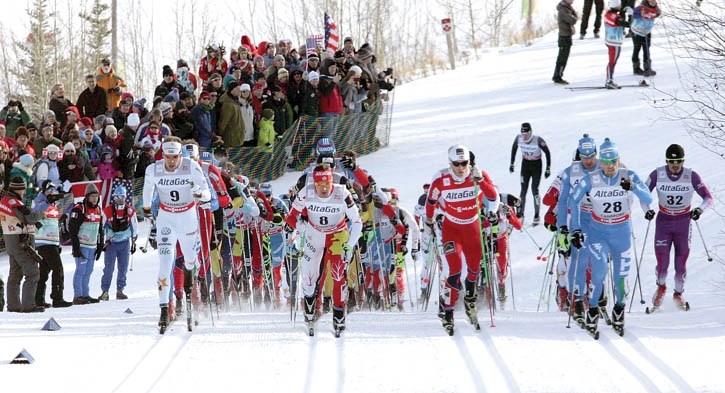 Ivan Babikov (8) leads the world’s best cross-country skiers up a climb during the 15 km classic.