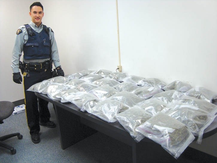 Canmore RCMP Cst. Dave Ling with 14 pounds on marijuana seized in a drug bust on the Trans-Canada Highway, Monday (Jan. 7).