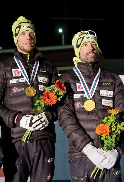 Brian McKeever, right, and guide Erik Carleton celebrate their gold medal in the classic sprint at the world championships in Sweden.
