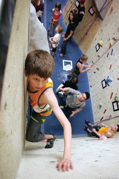 Gerald Kors of the Banff Climbing Team makes his way to the top of a bouldering route during Saturday’s (March 2) climbing competition at The Banff Centre.