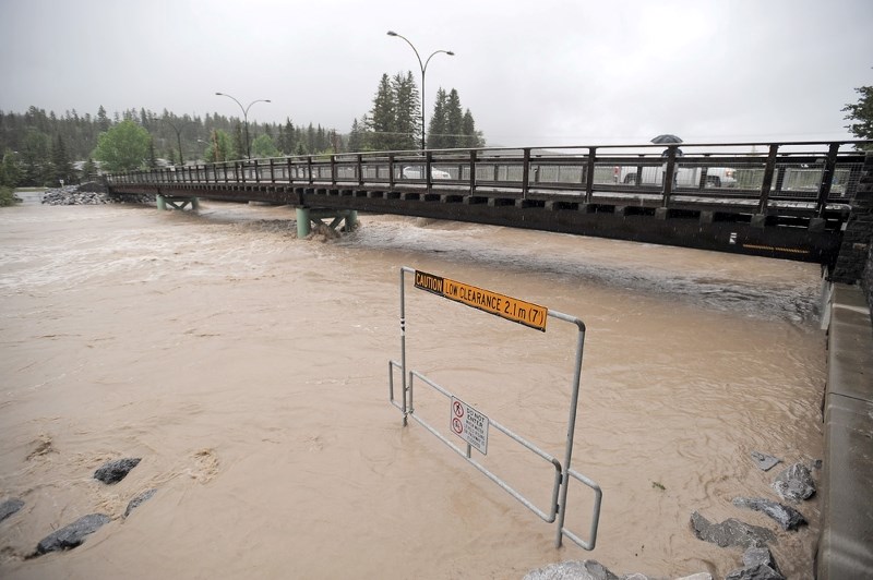 Water levels on the Bow River continue to rise in Canmore. Officials say at this point the bridge remains open for residents to cross.