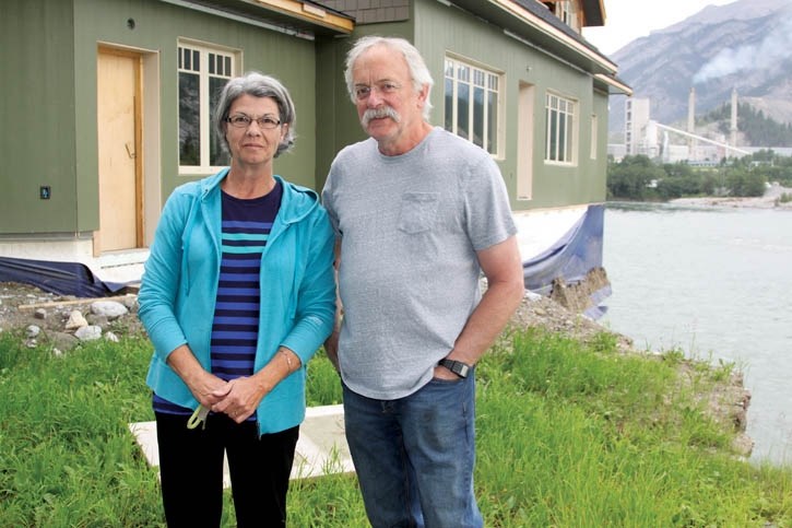 Nancy and Bob McGinn, whose Lac Des Arcs home was left partially hanging above the Bow River after June flooding washed away their property.