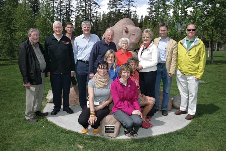 Friends of Bison Belong and Parks Canada representative Susan Staple (front right) gather at the bison statue in Banff Central Park in June to launch the new Bison Stroll.