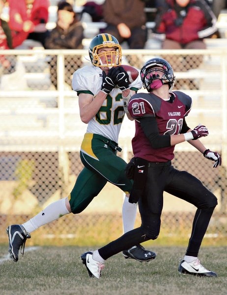 The Bow Valley Wolverines’ Alex Brown makes a huge gain catch along the sidelines on Foothills Falcon Trey Kellogg during their game at Foothills Composite High School in