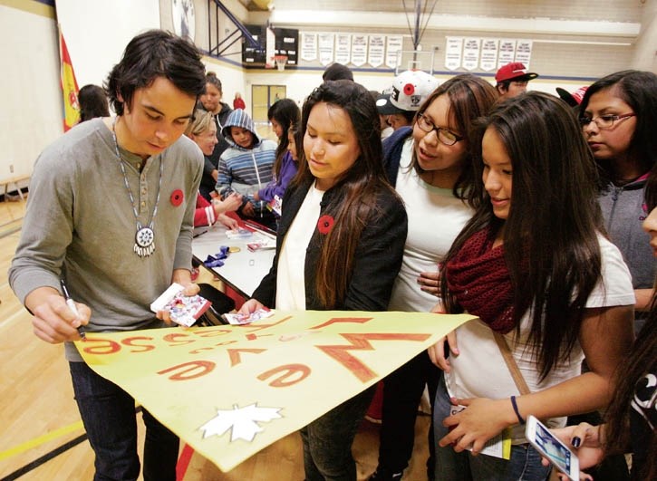 Cross-country skier and Olympic hopeful Jesse Cockney signs a poster for students and adoring fans at Morley School Friday (Nov. 8).