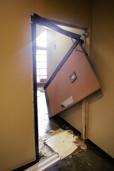 The Canmore Civic Centre’s women’s washroom door was blown from its frame after more than a metre of water built up inside.