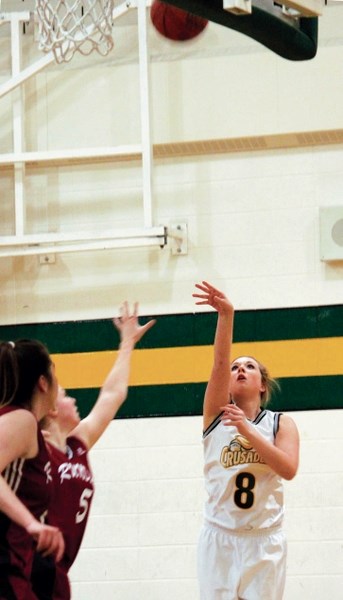 Canmore Collegiate High School’s Sarah Watts goes for two points during senior girl’s basketball action against Rundle College.